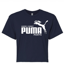 Load image into Gallery viewer, A navy blue short-sleeve crewneck t-shirt featuring a white graphic print on the front. The graphic displays the Puma leaping cat logo alongside the text 'HOPE I DONT PUMA PANTS'.
